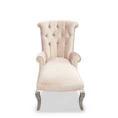 an upholstered white chair with silver legs and tufted back, on a white background