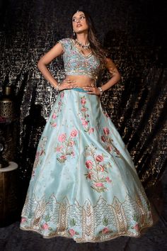 Sky blue flared raw silk kalidar lehenga with Phool gul resham thread embroidery and sequin, beads highlights. Paired with a cap sleeves floral garden embroidered flattering V neck blouse and a tassel embroidered border organza dupatta. - Aza Fashions Blue Silk Lehenga For Reception, Tussar Silk Anarkali Floor-length Set, Tussar Silk Palazzo Set For Wedding Navratri, Festive Tussar Silk Sets For Reception, Silk Lehenga With Unstitched Blouse In Blue, Anarkali Raw Silk Choli With Meenakari, Blue Silk Lehenga With Unstitched Blouse, Blue Designer Dress In Tissue Silk, Designer Blue Tissue Silk Dress