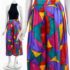 "- 70s/80s colorful satin pleated palazzo pants - rainbow pucci style print with accordion knife pleat - elastic waist - zipper and button back closure - single seam - some distressing Fits like:  S - M Material:  Polyester Condition:  Good (some small runs/stains) Clipped on Mannequin: Yes ✂ SIZE + FIT ✂ Length: 35\" / 89 cm Waist: 28\" to 34\" / 71 cm to 86 cm Hips: 56\" / 142 cm Inseam: 22\" / 56 cm Rise: 30\" / 76 cm All measurements are taken with garment lying flat. ALWAYS refer to measurements as vintage sizes can vary greatly from today's modern sizes. We recommend comparing measurements above with a similar style garment you own for best fit before purchasing.  DRESS FORM / MANNEQUIN is wearing the size detailed above but she typically measures a size 4/6 by modern retail sizes or Retro Multicolor Pleated Skirt Bottoms, Pleated Palazzo Pants, Dress Form Mannequin, Knife Pleat, Belt Accessories, Dress Form, Palazzo Pants, Capri Pants, Elastic Waist