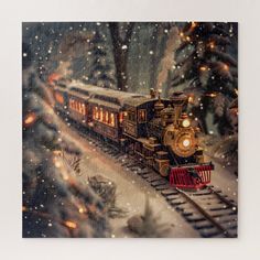 a christmas card with a train going down the tracks in the snow and lights on