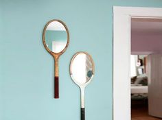 a racket mirror is hanging on the wall next to a mirror that says, careful now, your tennis racket's mirror, mirror, mirror, mirr, on the wall may have a backhanded response