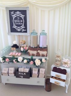 the table is set up with various items for sale at this wedding reception, including cookies and candy bars