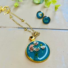 Make gifting easy! I have put together a really pretty set of handmade treasures. This necklace and earring set is handmade and assembled by me and made to order. 1-5 day shipping. I use resin, watercolor paint, watercolor paper, and flowers. I also use mustard seeds. They tend to resemble a sun but they represent faith in Jesus.  Necklace and earring set is 18 karat gold plated. Necklace length offered in (16, 18, 20 inch). ☀️ Your order will automatically be gift wrapped. All earring and neckl Handmade Dangle Jewelry Sets For Gifts, Bohemian Turquoise Jewelry Sets For Gifts, Personalized Round Turquoise Jewelry, Personalized Blue Bohemian Jewelry, Turquoise Necklace With Matching Earrings, Turquoise Necklace With Matching Earrings As Gift, Round Jewelry Sets For Mother's Day Gift, Bohemian Green Jewelry Sets For Gift, Mother's Day Adjustable Jewelry Sets Gift