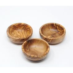 three wooden bowls sitting next to each other