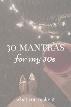 someone holding a wine glass with the words 30 mantras for my 30's