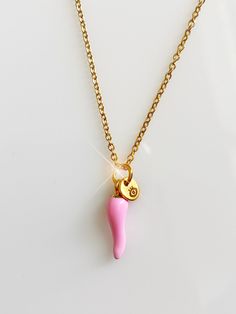 "New STYLEPRETTY IN PINK! One of a kind, for the minimalist, featuring a stainless steel PINK chili 🌶, (Cornicello) charmed with a stainless steel minimalistic evil eye tag.Two powerful protection pieces in one piece  Tarnish resistant chain!! 16 inches Custom freshàlamode jewelry pouch included.  The corno, or cornicello is an Italian amulet of ancient origin. Corno means \"horn\" and cornicello means \"little horn\". These names refer to a long, gently twisted horn-shaped amulet worn in Italy to protect against the evil eye. A regionally popular amulet, they are primarily found in Italy and in America among descendants of Italians. It's is known to be a popular charm to ward off the evil eye.  Comes in sleek FRESHALAMODE packaging making it perfect for gifting." Dainty Pink Charm Necklace With Adjustable Chain, Pink Metal Charm Necklaces With Lobster Clasp, Pink Metal Charm Necklace With Lobster Clasp, Handmade Pink Jewelry For Everyday Wear, Trendy Pink Sterling Silver Jewelry, Handmade Pink Everyday Jewelry, Pink Dangle Charm Necklace With Adjustable Chain, Pink Sterling Silver Charm Necklace With Adjustable Chain, Pink Sterling Silver Jewelry, Tarnish Resistant