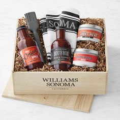 an open wooden box containing bottles of beer and grooms shaving brush on a marble countertop