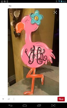 a pink flamingo standing on top of a table