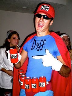 a man dressed up as a super hero with red cups in his hand and pointing at the camera