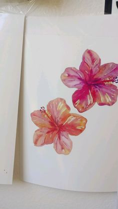 two cards with pink flowers on them sitting next to each other