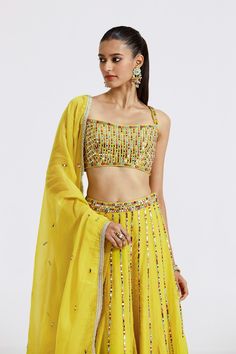 Stylish lemon yellow embellished organza lehenga is perfect for weddings. It comes with a dupatta. Shop online from Pure Elegance. Disclaimer: The actual product may vary slightly from the image. These are custom orders, hence expect slight variation in color and placement of the motif or buta. ESTIMATED DELIVERYBecause this is a custom order, it would take about 4 weeks from the date of purchase. RETURN POLICYThis product is a custom order and cannot be returned or exchanged. Embellished Yellow Sets For Diwali, Embellished Yellow Set For Diwali, Diwali Embellished Yellow Sets, Festive Yellow Embellished Anarkali Set, Festive Yellow Embellished Dupatta, Yellow Anarkali Set With Cutdana For Party, Yellow Organza Sets For Navratri, Yellow Embellished Bollywood Anarkali Set, Yellow Embellished Anarkali Set For Diwali