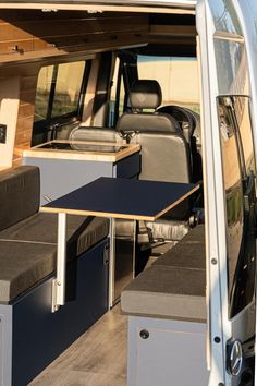 the interior of a van with seats and tables