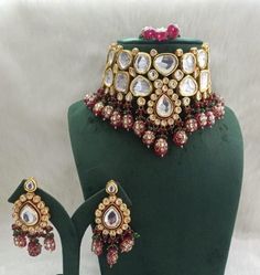 Product Description: * Sabyasachi inspired maroon kundan choker set, kundan bridal jewellery, tanjore kundan jewellery, Punjabi bridal jewellery, Indian jewellery * The base metal color is Gold tone studded with kundan along with beads work on it. * This Jewelry set would add more charms to your beautiful jewelry collection and would surely bring lots of compliments . * Note:- This is an artificial Jewelry Set. * Care Instructions: Keep it dust-free & dirt free in a plastic pouch. Remember t Kundan Bridal Jewellery, Kundan Choker Set, Copper Jewellery, Kundan Choker, Jewellery Indian, Choker Set, Bridal Jewellery Indian, Agate Jewelry, Onyx Bead