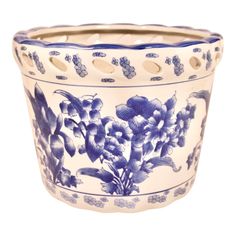 a blue and white flower pot with flowers on it