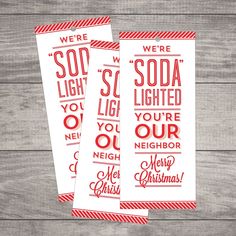 two red and white christmas movie tickets sitting on top of a wooden table