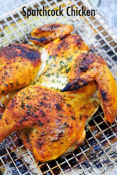 some chicken is cooking on a grill with the words, spatchock chicken simply gourmet