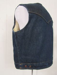 "Vintage 1970s denim synthetic fleece lined cowboy western vest. Has a snap front and two pockets. Label reads: DEE CEE BRAND SIZE XL. Actual measurements are: 45\" at the chest 42\" at the waist 16\" shoulder to shoulder 27\" overall length In excellent condition." Fitted Vintage Denim Vest For Winter, Fitted Denim Vest In Dark Wash For Winter, Fitted Dark Wash Denim Vest For Winter, Fitted Winter Denim Vest With Pockets, Winter Fitted Denim Vest With Pockets, Fitted Denim Vest With Pockets For Winter, Vintage Denim Vest In Medium Wash For Winter, Western Style Denim Vest For Fall, Western Style Vest With Pockets For Fall