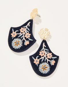 two pairs of earrings with flowers on them