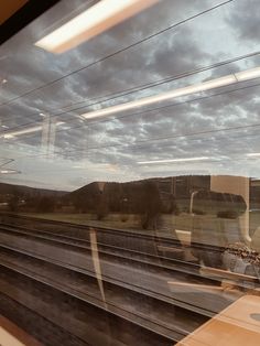 the view from a train window looking out at mountains