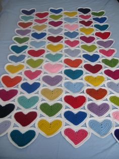 a crocheted blanket with many hearts on it