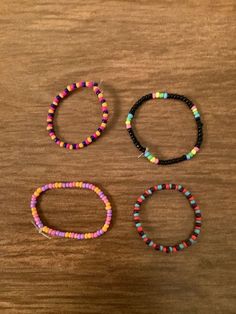 three bracelets sitting on top of a wooden table