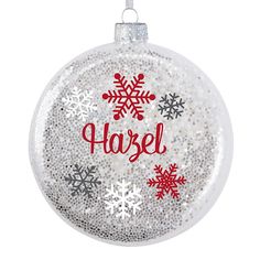 a glass ornament with snowflakes and the word harle on it