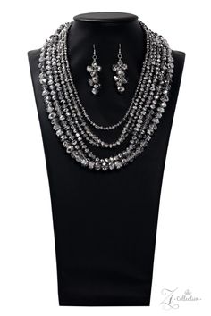 Dipped in half in a metallic shimmer, a scintillating collision of a faceted hematite and crystal-like beading drape across the chest for a spellbinding look. Held together by two silver fittings, the blinding strands gradually increase in size as they trickle down the chest fearless finish. Features an adjustable clasp closure. Sold as one individual necklace. Includes one pair of matching earrings 7/30/19 Adjustable Silver Rhinestone Necklace, Silver Necklaces With Round Beads For Party, Silver Necklace With Round Beads For Party, Silver Metal Beaded Necklaces For Party, Silver Metal Beaded Necklace For Party, Adjustable Silver Beaded Necklace For Party, Silver Round Beads Jewelry For Party, Elegant Silver Beaded Necklaces With Rhinestones, Elegant Silver Beaded Necklace With Rhinestones