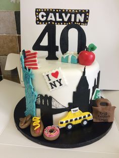 a birthday cake with the number forty on it and various items for each individual to decorate