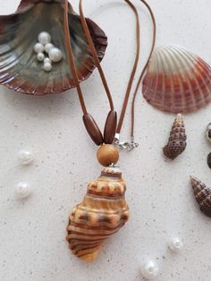 several seashells and pearls on a white surface