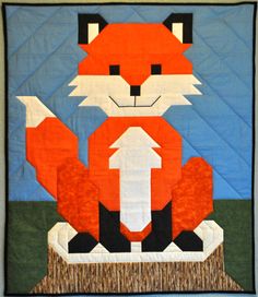 a quilted wall hanging with an image of a fox