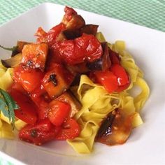 a white plate topped with pasta and vegetables