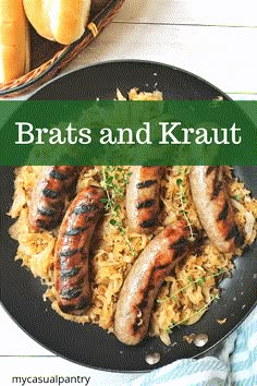 bratwursts and kraut on top of sauerkraut in a skillet