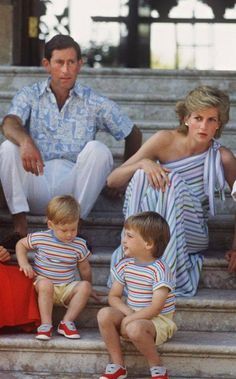 the prince and princess of wales are sitting on some steps with their children, including two boys