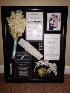 a wedding display with flowers and pictures on the wall next to it's frame