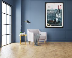 an empty room with blue walls and wooden flooring has a poster hanging on the wall