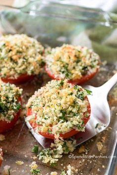 tomatoes stuffed with parmesan cheese and herbs on a baking sheet, ready to go into the oven