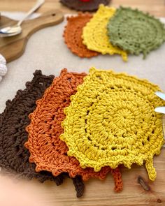 crocheted placemats are laid out on a table with utensils