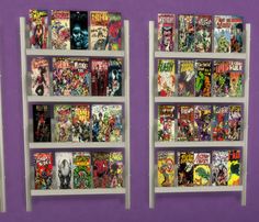 two shelves with comic books on them against a purple wall