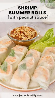 shrimp summer rolls with peanut sauce on a plate next to lettuce and peanuts