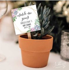 a potted plant sitting on top of a table with a sign in the middle