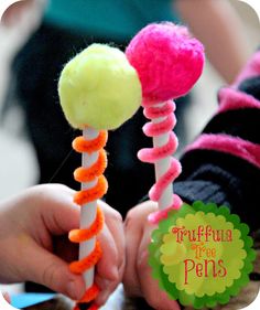 two children are holding colorful candy lollipops with the caption tuff - floss free pens