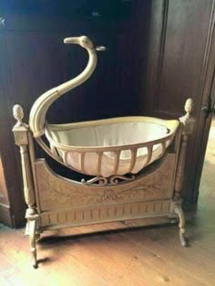 a baby crib with a swan shaped handle on it's head and legs