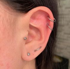 a woman with three piercings on her ear