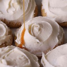 the icing is being drizzled onto some cookies