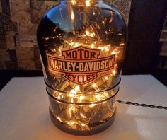 a lighted bottle sitting on top of a table