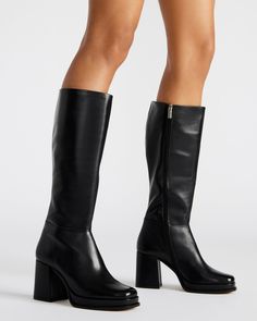 Crafted for ultimate sophistication, these knee-high boots boast a sleek square toe and sturdy block heel for effortless style. Elevate your wardrobe with the MYSTERY platform boot. 3.25 inch heel height 1 inch platform Size 6 measurements: 14 inch shaft circumference, 14.25 inch shaft height Size 8 measurements: 15.5 inch shaft circumference, 15 inch shaft height Size 10 measurements: 16 inch shaft circumference, 15.5 inch shaft height Leather upper material Textile and synthetic lining Synthet Faux Leather Knee-high Boots With Platform And Block Heel, Knee-high Chunky Platform Heeled Boots Medium Width, Knee-high Faux Leather Platform Boots With Stacked Heel, Trendy Knee-high Boots With Chunky Platform And Block Heel, Knee-high Chunky Platform Heeled Boots, Chic Knee-high Boots With Chunky Platform, Black Tall Platform Boots With Wide Calf, Wide Calf Square Toe Platform Boots With Stacked Heel, Tall Platform Boots With Stacked Heel And Wide Calf