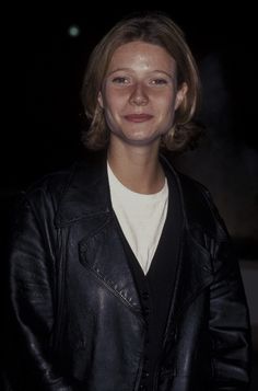 a woman wearing a black leather jacket and smiling