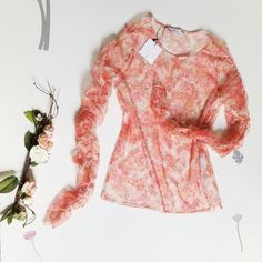 Long Sleeves With Stretch. Pretty Sheer With A Floral Print. 100% Polyester Feminine Spring Blouse With Stretch, Spring Stretch Blouse, Feminine Stretch Blouse For Spring, Elegant Floral Print Stretch Blouse, Elegant Stretch Floral Print Blouse, Feminine Sheer Blouse For Spring, Spring Sheer Pink Blouse, Pink Sheer Blouse For Spring, Sheer Pink Blouse For Spring