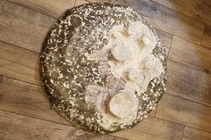 a round piece of bread sitting on top of a wooden floor