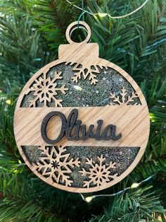 an ornament hanging from a christmas tree with snowflakes and the word ohia on it